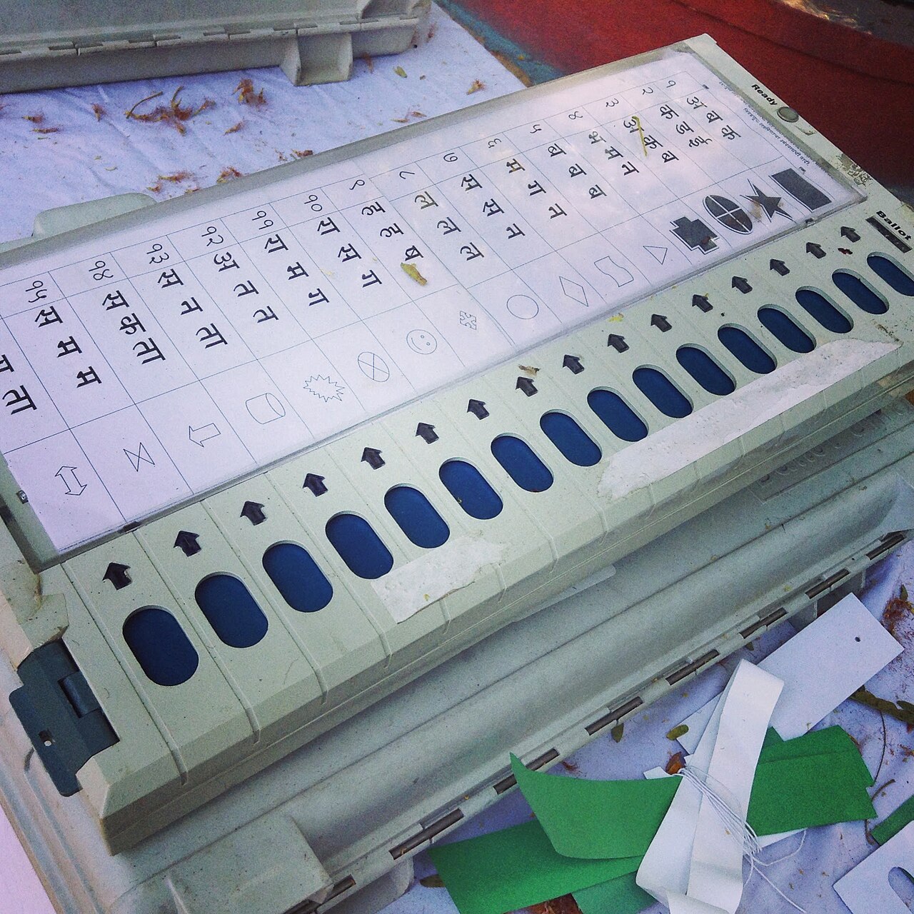 An Indian electronic voting machine with a row of candidate buttons.