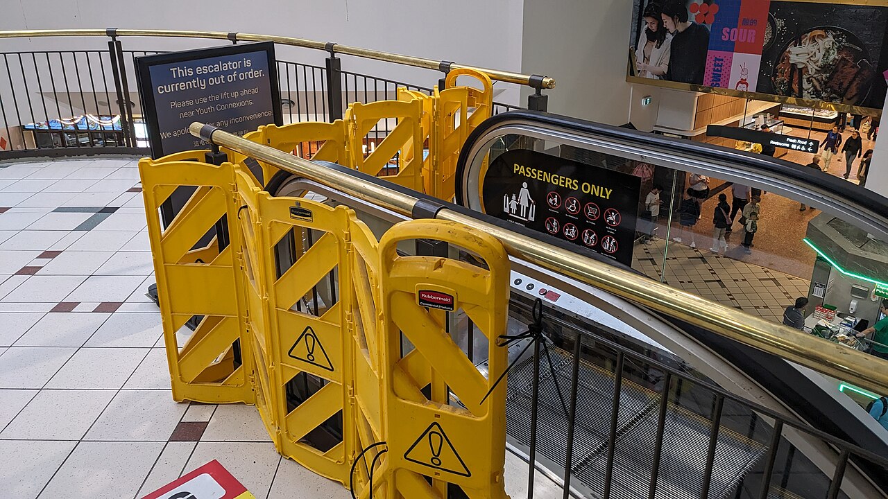 A closed escalator at Box Hill with a barrier across its entrance.