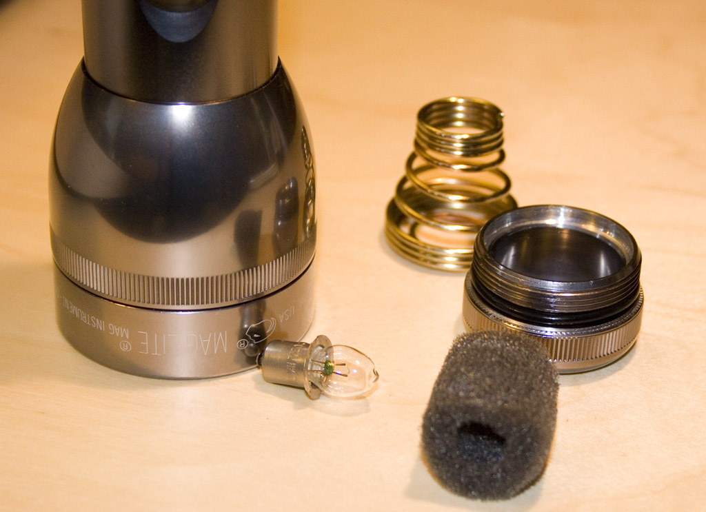 The removed tail cap of a Maglite, with its battery spring visible.