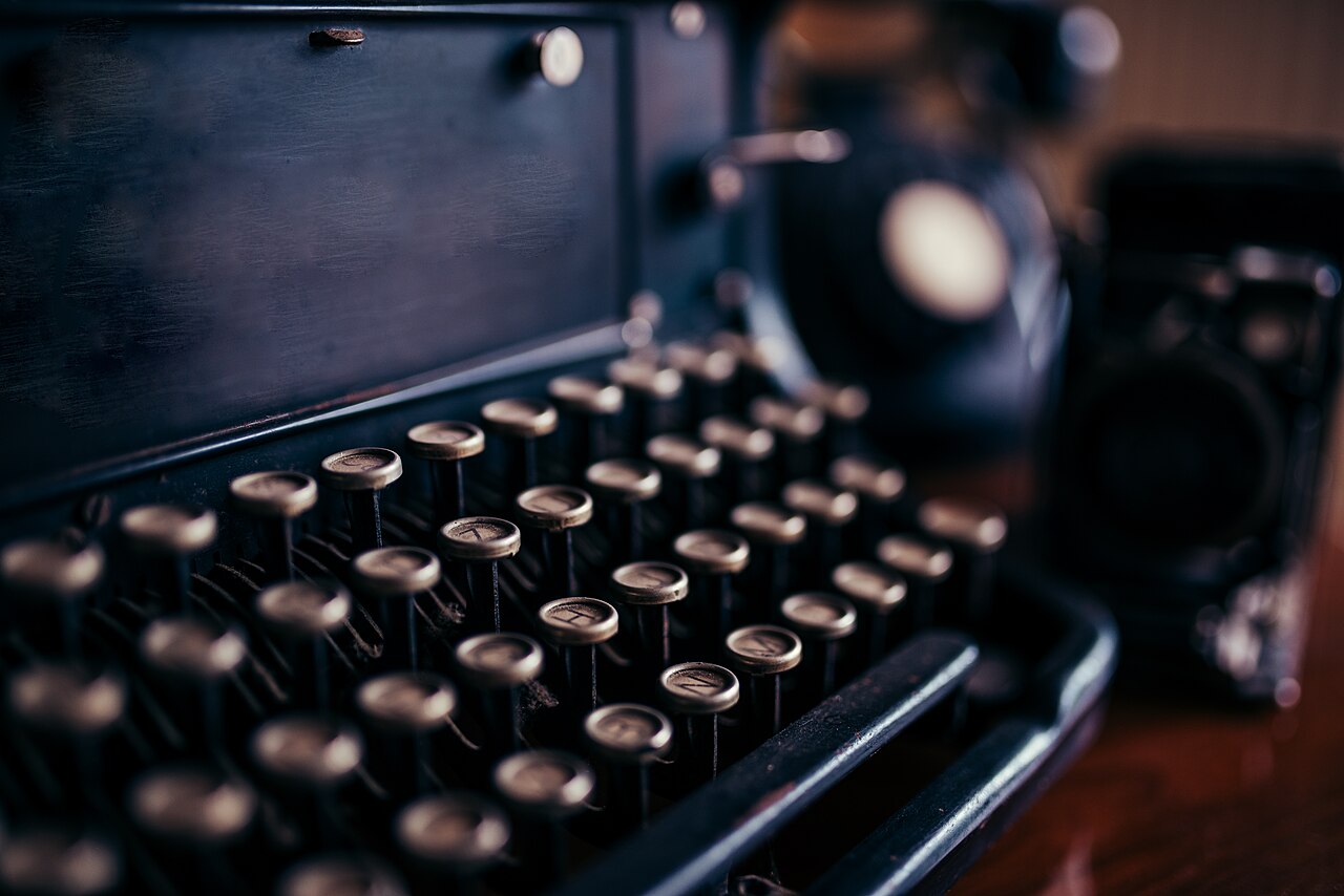 Round keys on an old typewriter, seen at an angle.