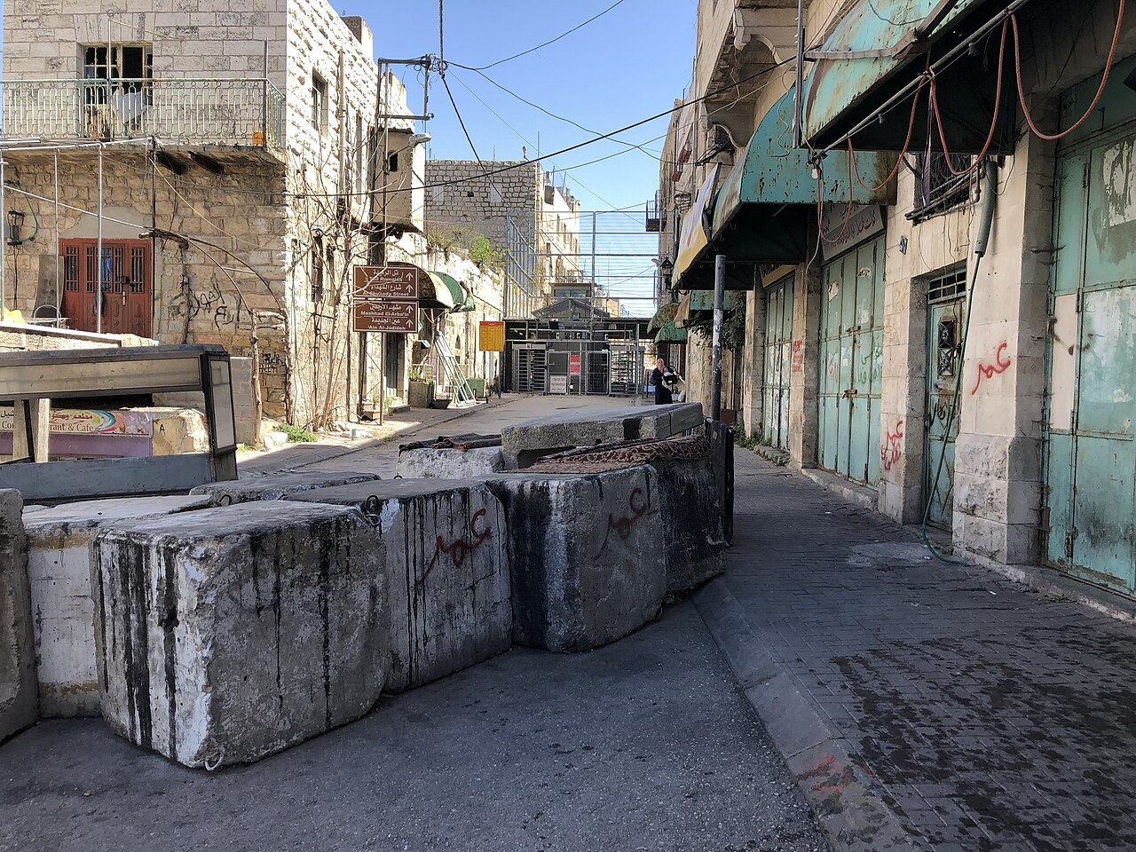 Concrete barriers across a market street in Hebron.