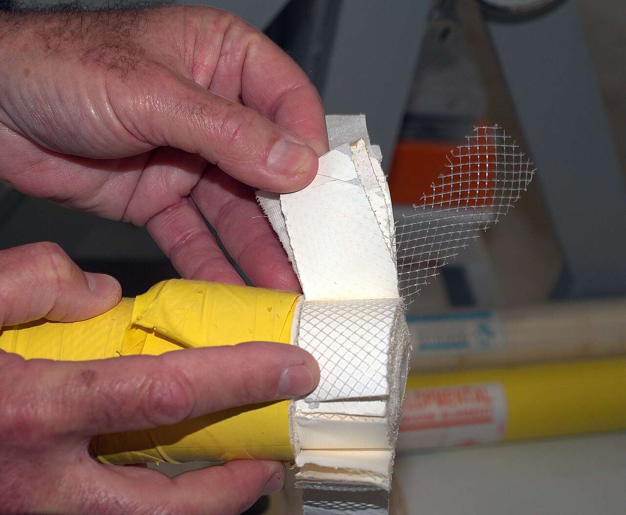 A reverse-osmosis membrane element opened to reveal its rolled layers.